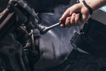 Technician working on checking and service car in workshop garage