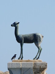 The port entrance of the Mandraki Harbor in Rhodes Town, Rhodes, Greece is guarded by a deer (Elafos) and a hind (Elafina