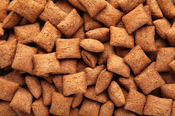 Chocolate pads corn flakes closeup background. Cereals texture.