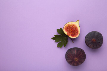 Fresh ripe figs on purple background. Tropical fruit