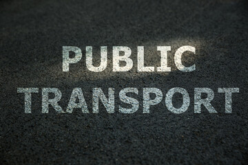 Fototapeta premium Text PUBLIC TRANSPORT written on asphalt road