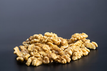 Walnuts in halves on black background