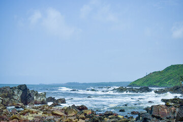 Fototapeta na wymiar Ocean-Sea Waves, Mountains Rock Stones and Sky Blue Landscape Background