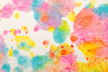 Watercolor background. Colored brush strokes of watercolor paint on white paper.