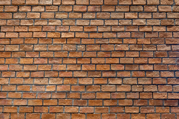 Photo of a wall made of red bricks, background from a wall built inside a building