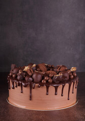 Delicious layered chocolate cake with decorations on dark