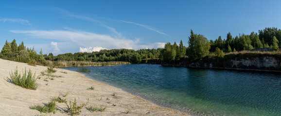 limestone mountains and calm blue groundwater lake in an old quarry