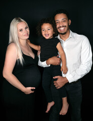 Stylish and happy multi-ethnic family expecting a baby