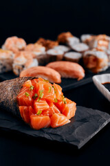 Temaki salmon on the table background dark