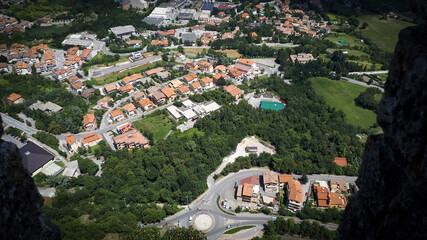 High angle shot of a beautiful city with colorful roofs and nature view of San Marino, Italy