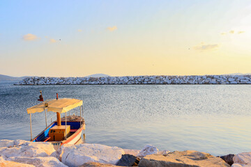 boat at the pier. Embankment, sunset over the sea, pleasure boat