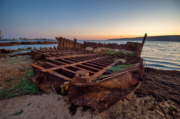 skeleton of an old boat by the sea