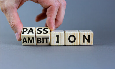 Passion or ambition symbol. Businessman turns wooden cubes and changes the word 'ambition' to 'passion'. Beautiful grey table, grey background, copy space. Business, passion or ambition concept.