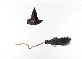 black broom and witch hat isolated on white background