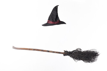 black broom and witch hat isolated on white background