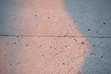 a concrete wall illuminated by the setting sun