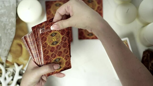  Blurred  Close up footage of two hands shuffling and adjusting tarot cards. Esoteric concept, fortune telling and predictions