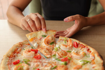 Female hands take a slice of pizza