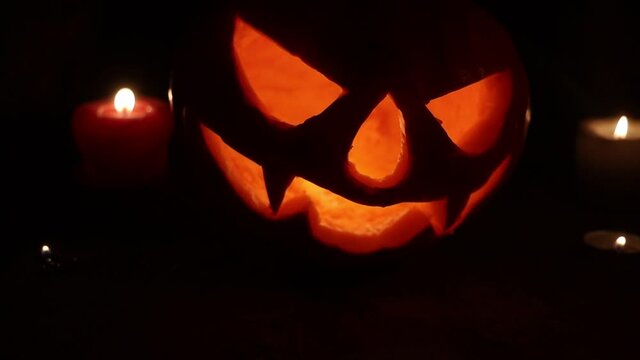 pumpkin head and candles in the night