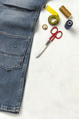 Handicraft, clothing repair. Ripped blue jeans sewing accessories