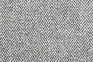Full frame grey and white textured herringbone furnishing or fashion fabric