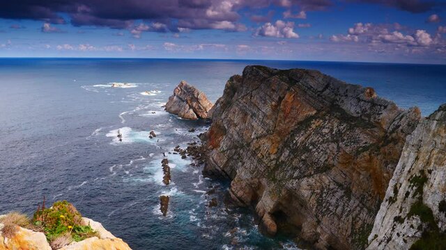 Seascape of Atlantic ocean and Asturias rocky coast at Cape Penas. Sea shore with high cliffs in north Spain.