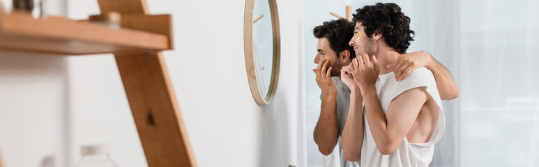 happy gay couple applying eye patches in bathroom, banner