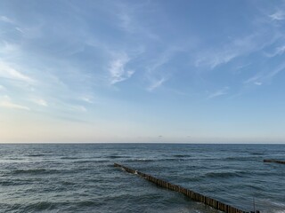 Fototapeta premium Breakwater construction in the sea, sea horizon, natural colors, romantic atmosphere 
