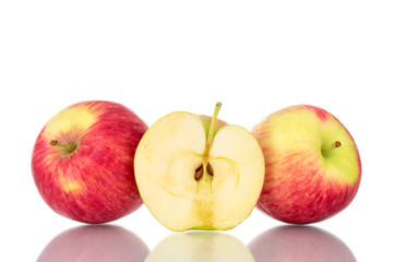 Naklejka na ściany i meble One half and two whole juicy apples, close-up, isolated on white.