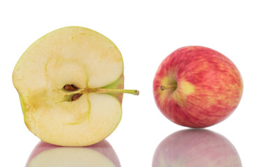 One half and one whole juicy apples, close-up, isolated on white.