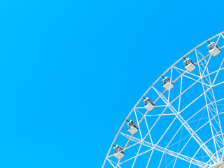 big ferris wheel against a blue cloudless sky, copy space