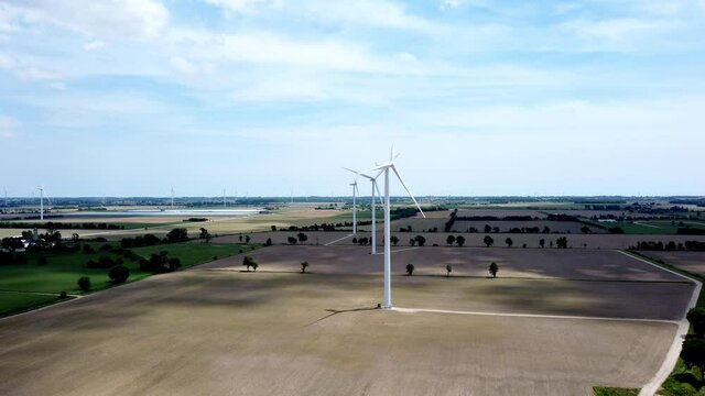 Renewable energy being generated by wind turbines on farmland creating sustainable electricity