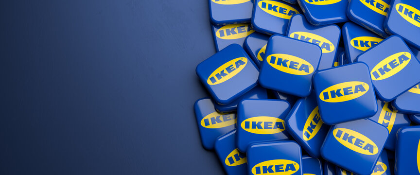 Logos of the Swedish conglomerate and furniture company IKEA on a heap on a table. Copy space. Web banner format.