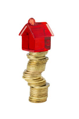 A small red toy house stands on a crooked, wobbly stack of yellow gold coins, isolated on a white background. Economic concept of profit growth, real estate investment, mortgage and capital