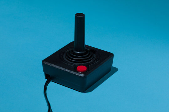 Vintage joystick with red buton on blue background
