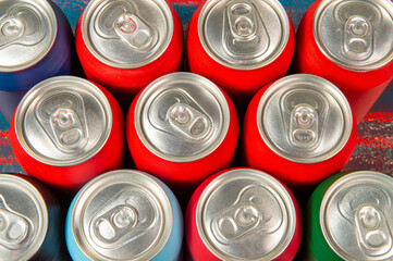 several aluminum soda cans in assorted colors