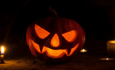 pumpkin head with candles in the dark on halloween night