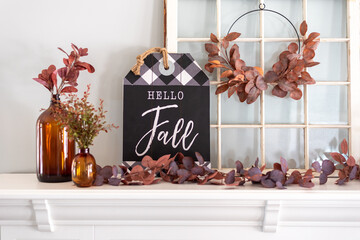 Hello fall sign on white mantel styled for fall