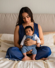 Mom and baby sitting in bed