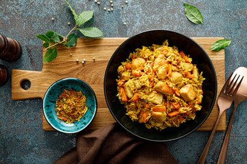 Pilaf or pilau with chicken, traditional uzbek hot dish of boiled rice, chicken meat, vegetables...