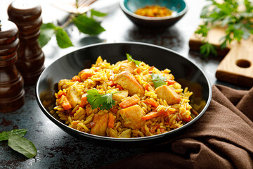 Pilaf or pilau with chicken, traditional uzbek hot dish of boiled rice, chicken meat, vegetables...