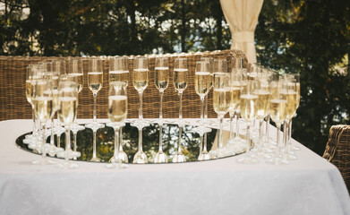 glasses with champagne on the table outdoors, wedding buffet