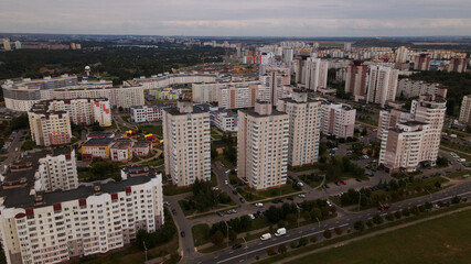City block. Modern multi-storey buildings. Flying at dusk at sunset. Aerial photography.