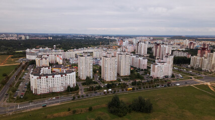 Obraz premium City block. Modern multi-storey buildings. Flying at dusk at sunset. Aerial photography.