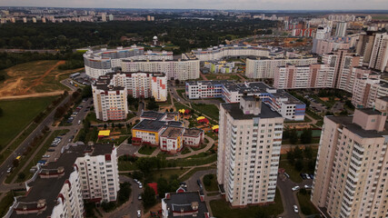 City block. Modern multi-storey buildings. Flying at dusk at sunset. Aerial photography.