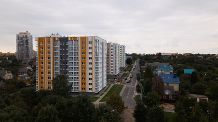 Fototapeta na wymiar City block. Modern multi-storey buildings in the private sector. Flying at dusk at sunset. Aerial photography.