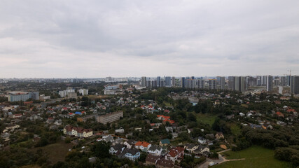 Obraz premium City block. Modern multi-storey buildings in the private sector. Flying at dusk at sunset. Aerial photography.