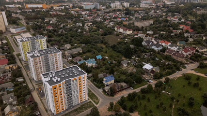 City block. Modern multi-storey buildings in the private sector. Flying at dusk at sunset. Aerial photography.