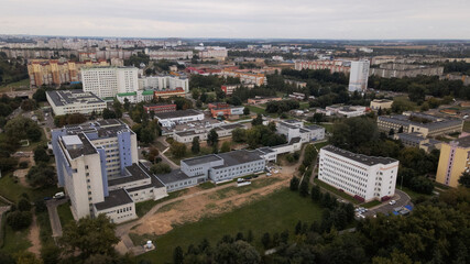 Obraz premium City block. Modern multi-storey buildings. Flying at dusk at sunset. Aerial photography.
