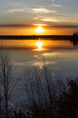 Fototapeta na wymiar A Glowing, Colourful Sunset at Astotin Lake